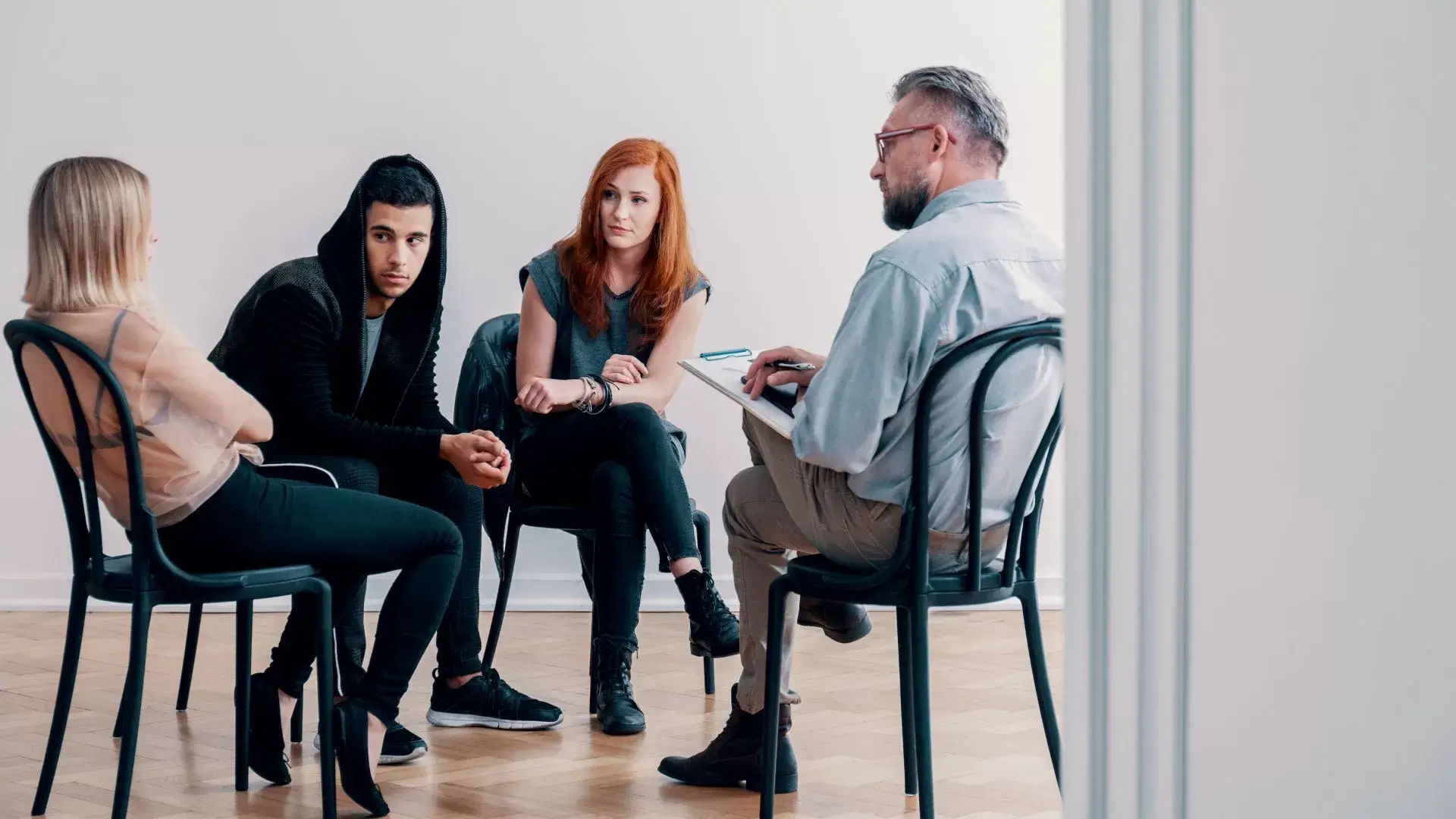 Family members in a counselling session with a therapist, representing how Family Systems Therapy at Oakville Family Counselling Therapy supports healing from abuse and rebuilding healthy family dynamics.